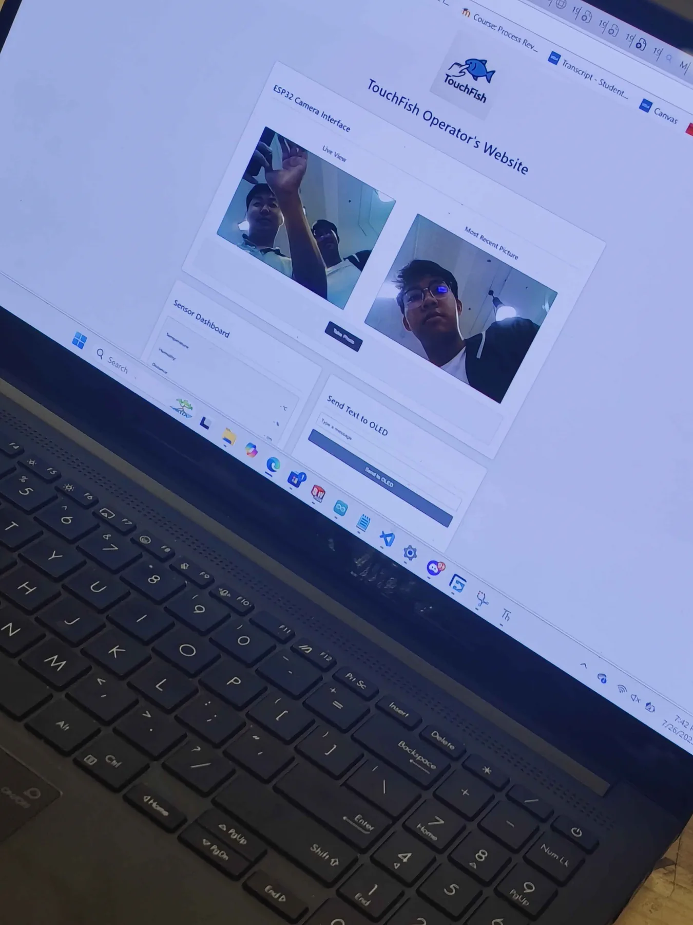 Laptop screen showing a web dashboard with two camera images of students.